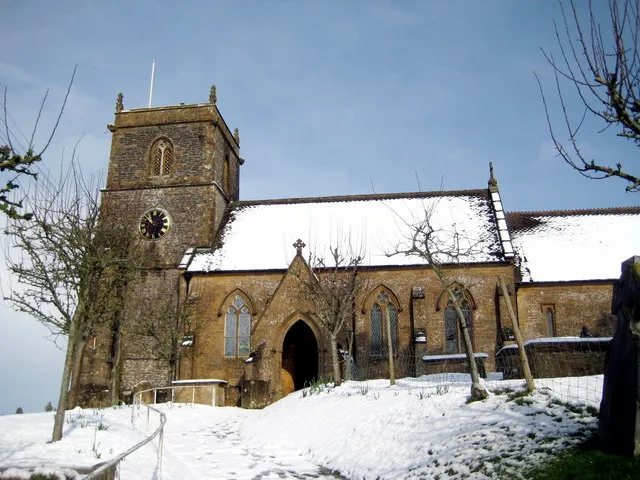Nave and west tower of the Blessed Virgin Mary parish church, Hardington Mandeville, Somerset, seen from the south in snow