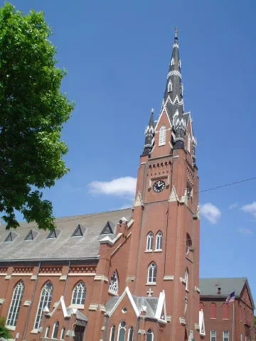 The exterior of Saint Mary's Church, Dubuque, Iowa, United States. This shows the steeple and the exterior of the church. This is an image of a place or building that is listed on the National Register of Historic Places in the United States of America. Its reference number is 15000436 (Wikidata).