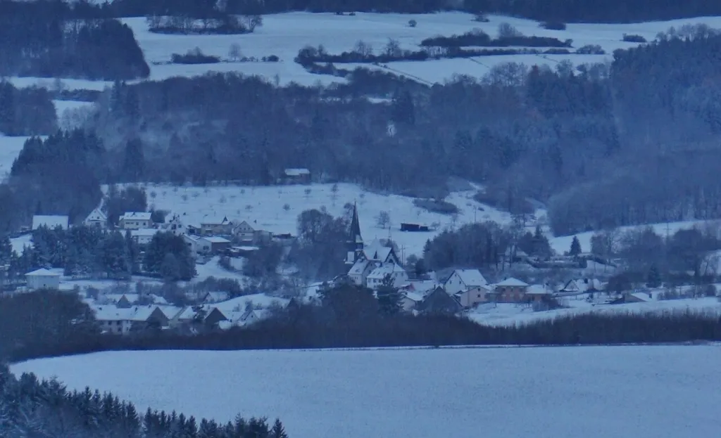 View of the snowy Berglangenbach (Germany) from Heimbach. In the centre the church of Berglangenbach can be seen.