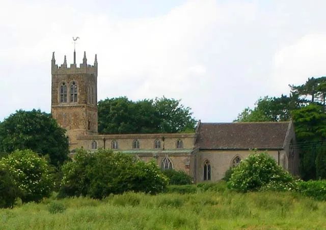 All Saints parish church, Pytchley, Northampotonshire, seen across the field from the bottom end of Pytchley