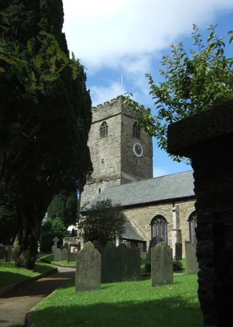 St Petroc's church, Padstow The tower and south porch seen through the churchyard from Church lane. There has been a church on this site since time immemorial, but although the foot of the power is C12th and the majority of the church dates from the C15th.