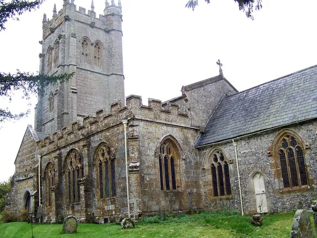 All Saints' parish church, Piddletrenthide, Dorset, seen from the southeast. The tower is mostly built of Purbeck stone; the windows and openings are in Ham Hill stone.