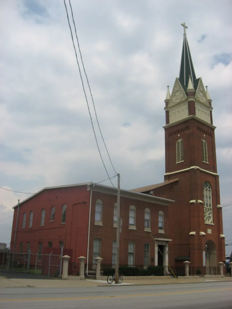 Front and western side of St. Patrick's Catholic Church, located at 1301-1305 W. Market Street (U.S. Route 31) in Louisville, Kentucky, United States. Built in 1853, St. Patrick's was the first North American parish to host a chapter of the Society of Saint Vincent de Paul. The two are listed together on the National Register of Historic Places.