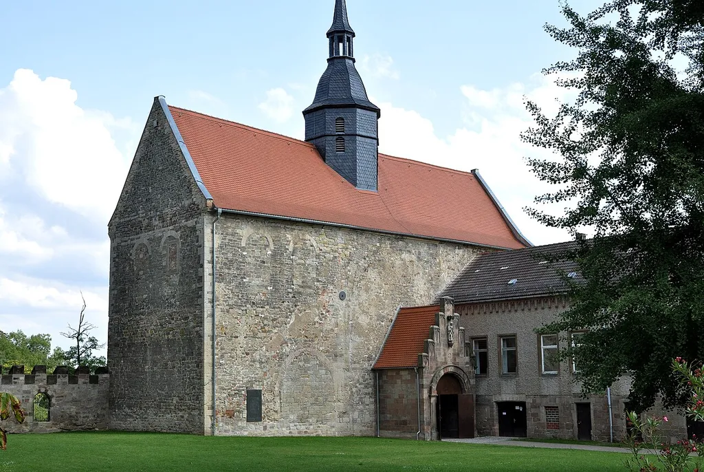 View to the church. From the court the transept can be seen with the brickes arcs of the former northern aisle ond the nave.