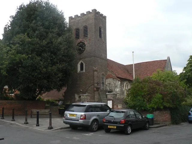 Shepperton: parish church of St. Nicholas. The parish church of Shepperton stands some distance from what would now be considered the village centre  this is Old Shepperton, about ½ mile southwest from the main shopping area and railway station. It may be that the arrival of the railway drew the main business of the village nearer to the terminus. This is a photo of listed building number 1178304.
