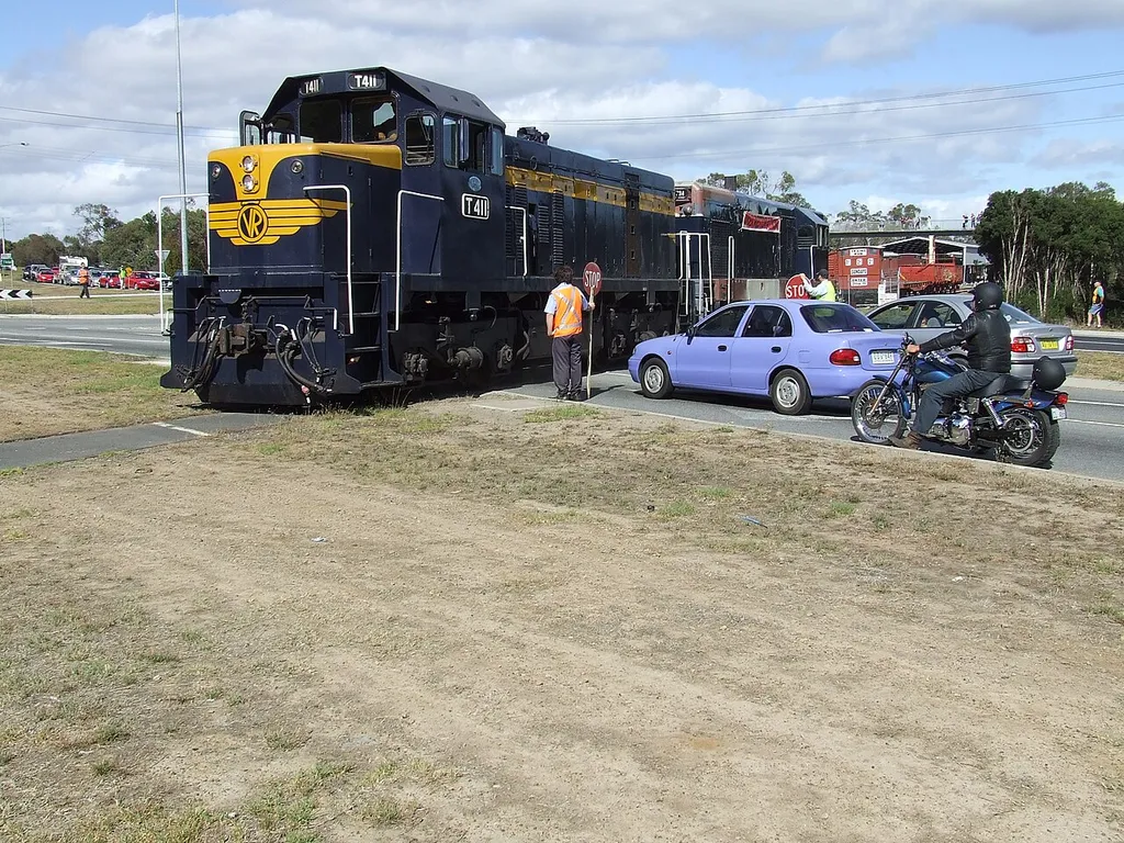 Photograph of a diesel train crossing Moorooduc Highway, near Moorooduc railway station, Melbourne.