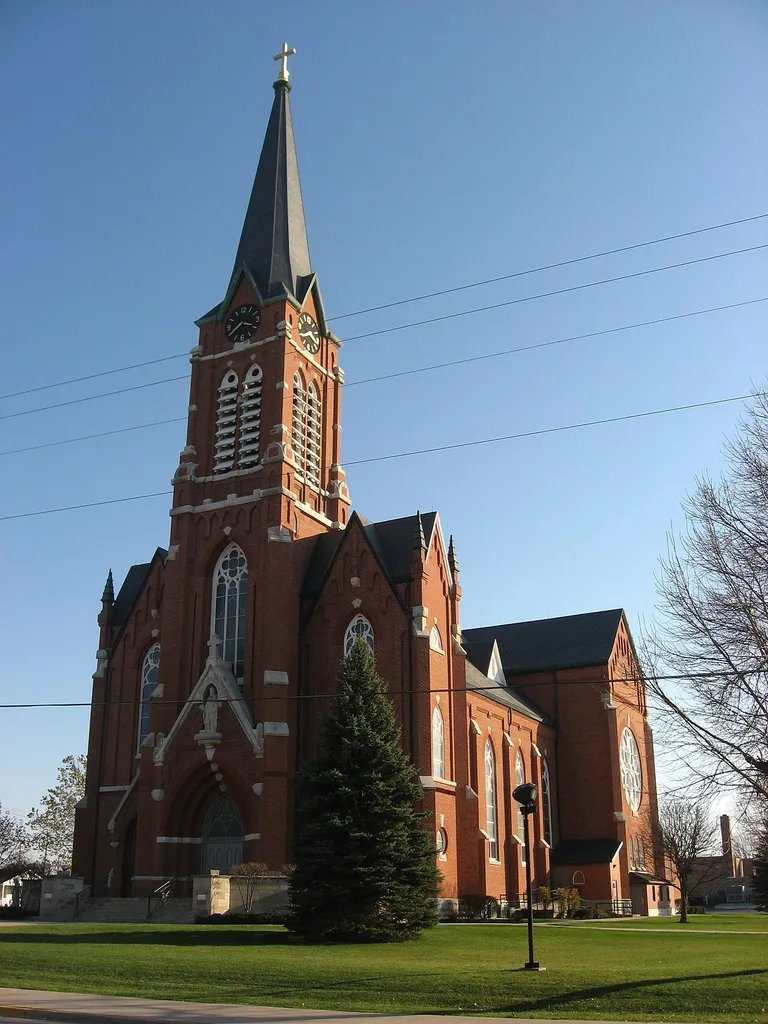 Front of St. Henry Catholic Church, located along State Route 119 in St. Henry, Ohio, United States. Built in 1892, the church was listed on the National Register of Historic Places as a part of the Cross-Tipped Churches of Ohio Thematic Resources.