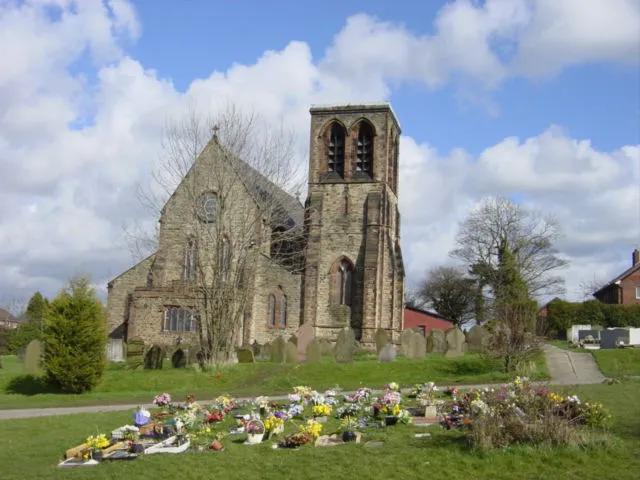 St Nicholas' parish church, Whiston, Merseyside, seen from the west. G.E. Street designed the church and intended tower to have a spire. Mining subsidence prevented from being added.