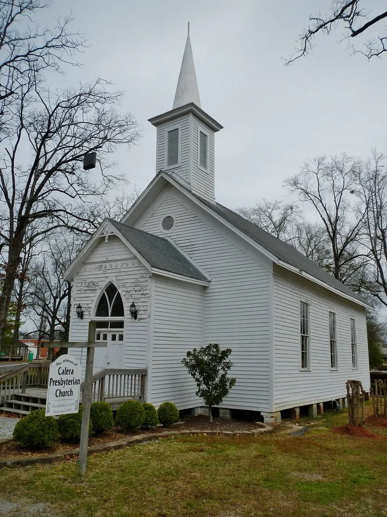 This is a photo of the Historic Calera Presyterian Church. The Calera Presbyterian Church is the oldest church building in the City of Calera, and one few remaining structures that date from the early town history. Now on the Historical Register, the church was donated to the city a few years ago. A Presbyterian congregation was first organized in 1872, and the church building was completed and occupied in 1885. Its original location was the corner of present day Highways 25 and 31, now the site of Calera High School. In 1885 the church had a membership of 60 which later declined, and by 1918 only 5 members remained. The church building, which at times has been unused, has, on occasion, been occupied by other denominations and also by the school. In 1929 it was moved across the block to its present location at the corner of Twentieth Avenue and Fourteenth Street. It is adjacent to Akridge Arboretum and the Senior Citizens' Center.