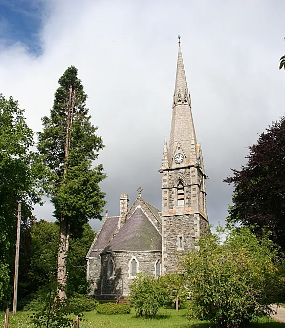 Braemar and Crathie Parish Kirk. Seen from the east with the morning sun on the apse and spire. The parish includes Crathie, the kirk where Her Majesty the Queen attends services while in residence at Balmoral Castle. Note that the gridline bisects the kirk so this end is in this square and the other end in the next square.