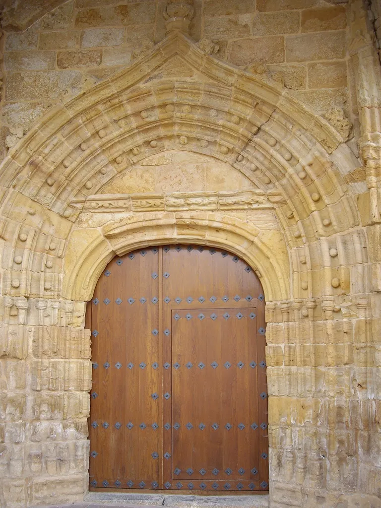 Church of the Assumption of Our Lady in Arnuero (Cantabria, Spain). XVth-XVIth centuries. Late Gothic architecture. Arch door on the Western façade, it lies below the tower.