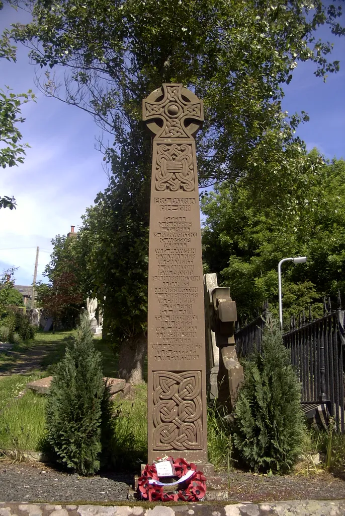 The graveyard war memorial, St Bees priory, Cumbria. It was designed by the famous scholar of Northumbrian art W G Collingwood, who was John Ruskin's secretary, at the request of Lt-Col George Dixon. The other war memorial, "St George and the Dragon", designed by local artist J D Kenworthy, is at the railway station.
