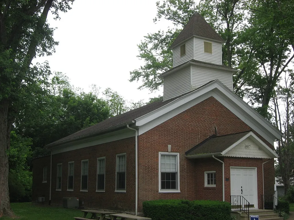 Front and eastern side of the former Putnamville Presbyterian Church (now the Putnamville United Methodist Church), located along U.S. Route 40 Putnamville, Indiana, United States. Built in 1834, it is listed on the National Register of Historic Places.