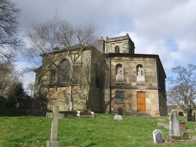 St Michael's parish church, Madeley, Shropshire, seen from the southeast. Centre left behind the birch tree is the chancel added in 1910.
