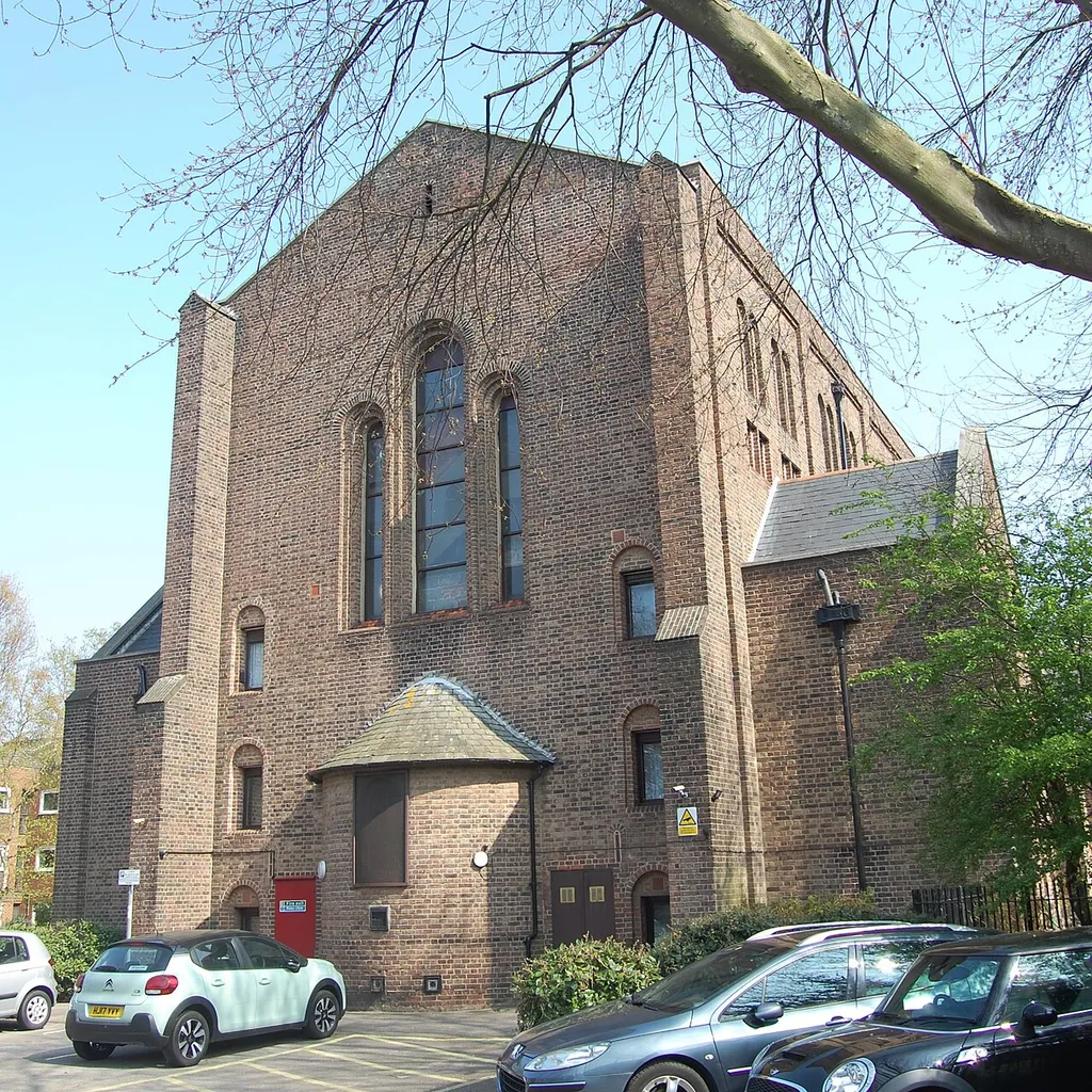 Former St John the Baptist's Church, Simpson Road, Rudmore, City of Portsmouth, England. Built in 1915–16 to the design of J.D. Coleridge as the Anglican parish church of the Rudmore area, near the present International Port and south of Stamshaw. Converted to flats in 1986–87 after closure in the 1970s.
