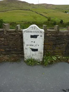 Milestone, Burnley Road; as road goes over railway, SE of bend