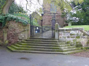 Gates, overthrow and gate piers to the Churchyard of St Bartholomew