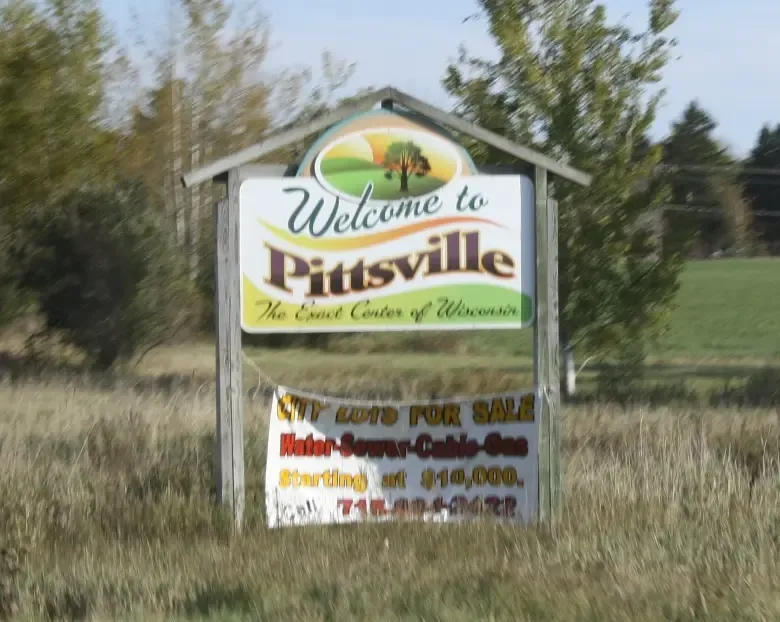 Looking east at the welcome sign for w:Pittsville, Wisconsin on w:Wisconsin Highway 73 / w:Wisconsin Highway 13.