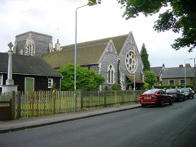 Church of All Saints, Murston. Originally 12th century, rebuilt in 1873 by William Burges. Large plate tracery rose window in west gable. The church stands in the north east corner of the square.