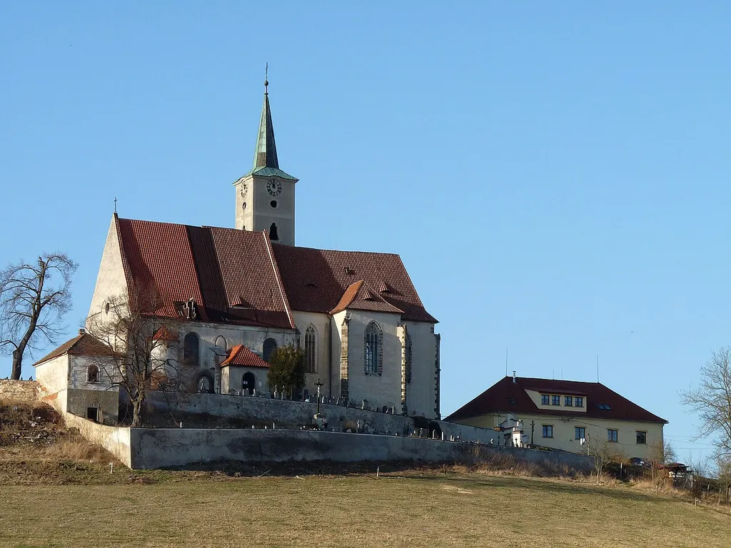 Church of the Assumption in the municipality of Nezamyslice, Klatovy District, Plzeň Region, Czech Republic and the former village school on the right