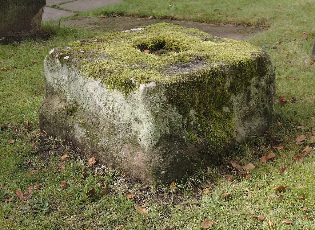 Grade II listed medieval stone cross base north of the lych gate of St Helen's church, Sefton.