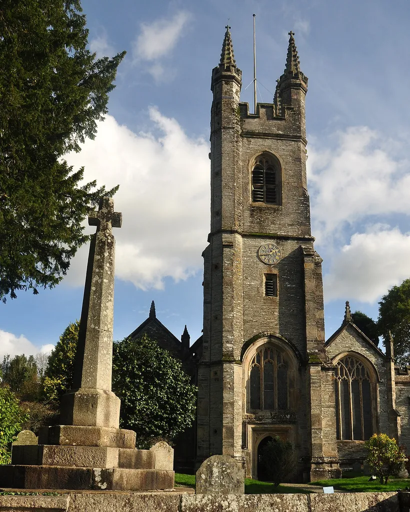 The Church of St Andrew in Buckland Monachorum, Devon, with the Jubilee cross in the foreground.