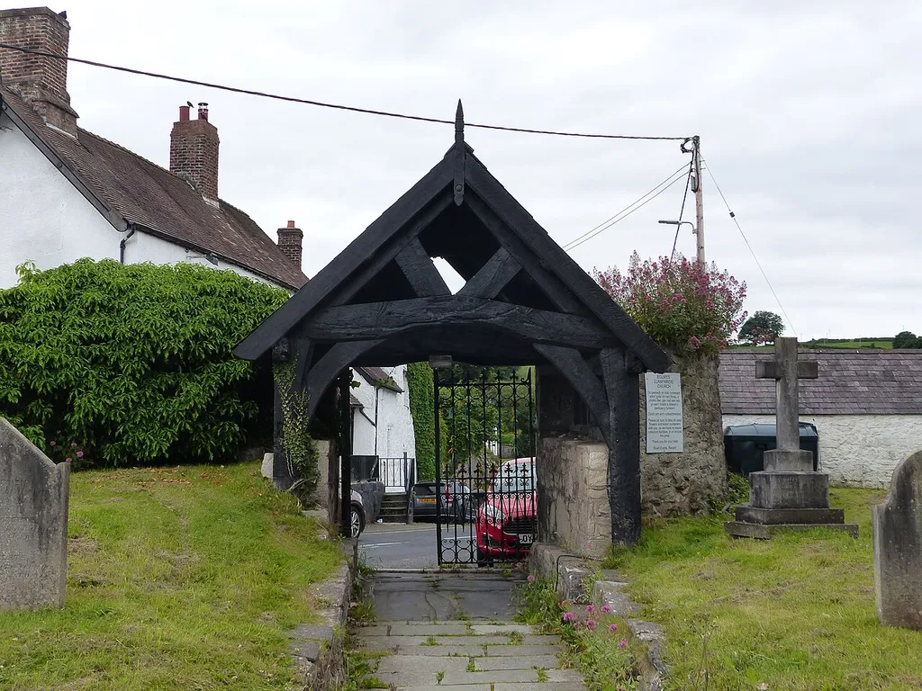 Lychgate W of Church of St Mwrog: Grade II listed building in Llanfwrog, Denbighshire. .mw-parser-output .messagebox{margin:4px 0;width:auto;border-collapse:collapse;border:2px solid var(--border-color-progressive,#6485d1);background-color:var(--background-color-neutral-subtle,#fbfcff);color:var(--color-base,#202122);box-sizing:border-box;border-inline-start-width:8px}.mw-parser-output .messagebox.mbox-small{font-size:88%;line-height:1.25em}.mw-parser-output .mbox-warning,.mw-parser-output .mbox-speedy{border:2px solid var(--border-color-error,#b22222);background:var(--background-color-error-subtle,#ffdbdb);border-inline-start-width:8px}.mw-parser-output .mbox-serious,.mw-parser-output .mbox-delete,.mw-parser-output .mbox-stop{border:2px solid var(--border-color-error,#b22222);border-inline-start-width:8px}.mw-parser-output .mbox-issue,.mw-parser-output .mbox-content{border:2px solid #f28500;background:var(--background-color-warning-subtle,#ffe);border-inline-start-width:8px}.mw-parser-output .mbox-query,.mw-parser-output .mbox-style{border:2px solid #f4c430;background:var(--background-color-warning-subtle,#ffe);border-inline-start-width:8px}.mw-parser-output .mbox-shit{border:2px solid #960;border-inline-start-width:8px}.mw-parser-output .mbox-license{border:2px solid #88a;border-inline-start-width:initial}.mw-parser-output .mbox-legal{border:2px solid var(--border-color-notice,#666);background:var(--background-color-base,#fff);border-inline-start-width:8px}.mw-parser-output .mbox-honor{border:2px solid #ca3;background:var(--background-color-warning-subtle,#fcf4db);border-inline-start-width:8px}.mw-parser-output .mbox-growth{border:2px solid #8d4;background:var(--background-color-success-subtle,#d5fdf4);border-inline-start-width:8px}.mw-parser-output .mbox-move{border:2px solid #93c;border-inline-start-width:8px}.mw-parser-output .mbox-protection,.mw-parser-output .mbox-message{border:2px solid var(--border-color-base,#aaa);border-inline-start-width:8px}.mw-parser-