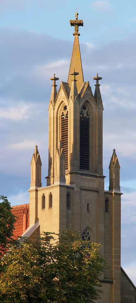 The steeple (and parts of the roof) of the protestant church in Rottenburg am Neckar seen during sunrise.