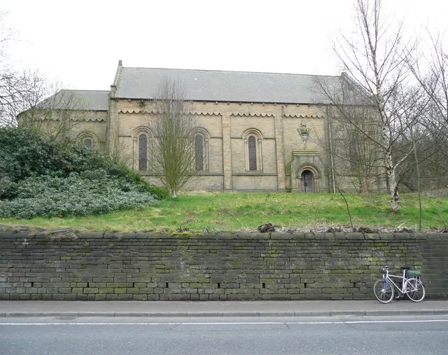St Luke's Church, Manchester Road A62, Milnsbridge, Linthwaite has a neglected look about it, the grounds are overgrown with greenery and the roof has several sizeable holes in it. It is now privately owned and being used as a storage unit. It was altered in 1861 by the architect James Pigott Pritchett (1789-1868). Perhaps he modified the Classical simplicity of the late 18C or early 19C by adding decoration such as the wavy lines over the window recesses.