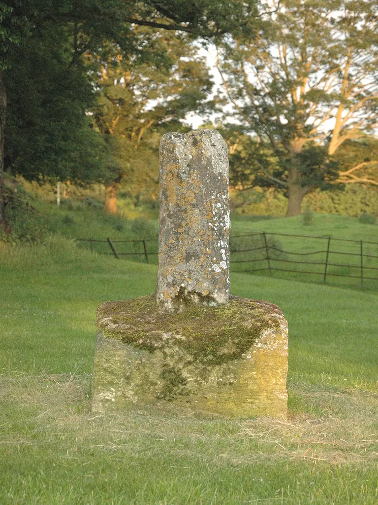 Base and broken shaft of Mediæval stone cross outside All Saints' parish churchyard, Middleton Stoney, Oxfordshire