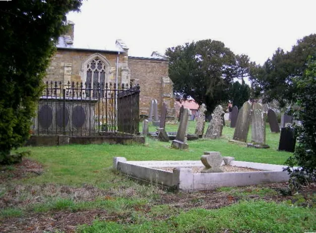 Part of St Helen's parish churchyard, Barkestone Road, Plungar, Leicestershire, seen from the south. On the left surrounded by railings is the Smith family tomb, built about 1800.