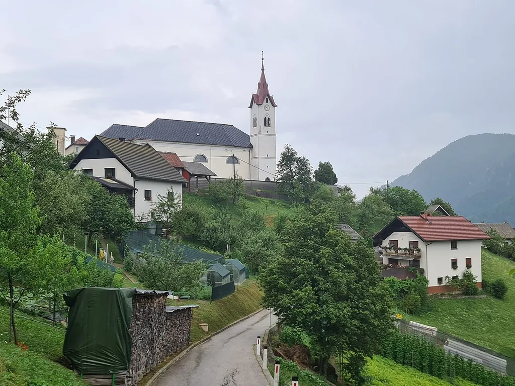 Otalež, a village above the right bank of the Idrijca in the Cerkno Hills (Slovenian Littoral, western Slovenia), with the parish church of St. Catherine.