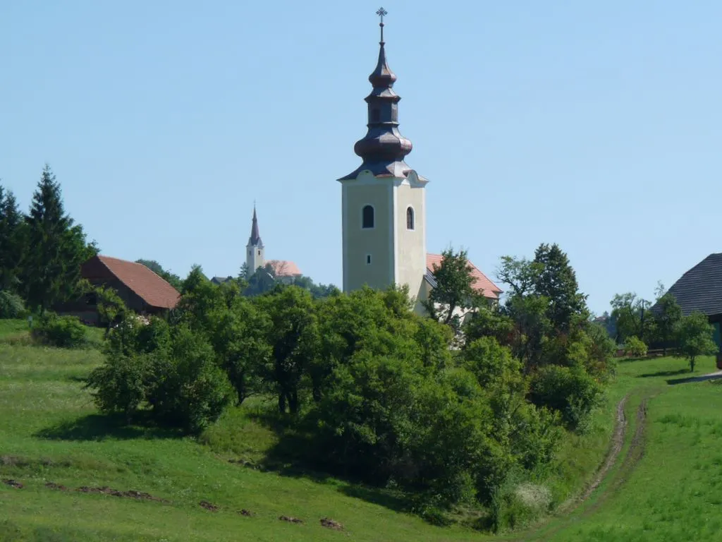 Dobje pri Lesičnem (St. Oswald's Church). In the back, St. Anne's Church in Lopaca.