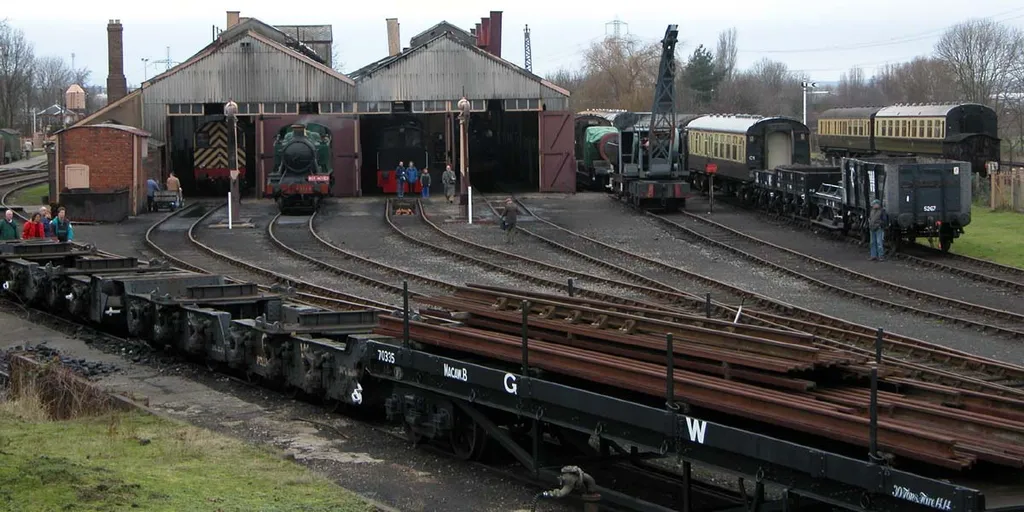 A general view: Didcot Railway Centre. The main building is the engine sheds. Visible inside is a BR 08 class shunter, a GWR class 45xx Prairie tank. The running track is off to the right of the picture. The tea shop is off to the left. Behind the engine sheds are the locomotive repair sheds; behind those are the carriage sheds.