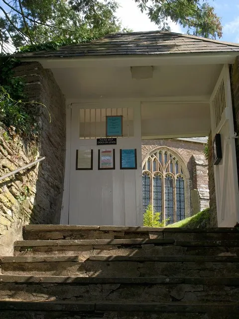 Lych gate, Slapton. Steps at the top of 1363206 lead up to the lych gate and the churchyard of St James' church. The lych gate is "early C19 with later C19 roof and gates" https://historicengland.org.uk/listing/the-list/list-entry/1325135 .