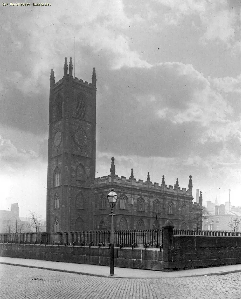 Former parish church of St John, Manchester, England, seen from the southwest circa 1900. Photograph taken by RA Pattrieoux (1863–1938) as part of a survey of Mancunian buildings by the Manchester Amateur Photographic Society.