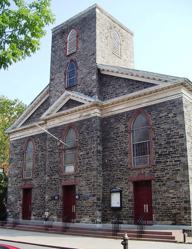 St. Augustine's Church at 290 Henry Street between Montgomery and Grand Streets in the Lower East Side of Manhattan, New York City, was built in 1827-29 as the All Saints' Free Church, and was constructed out of Manhattan schist. The Georgian-Gothic design is credited to John Heath, and includes a double pediment and a projecting tower. The church was enlarged in 1848. In 1949, the congregation merged with St. Augustine's Chapel of Trinity Church, located at 107 East Houston Street, and the new combined congregation used the sanctuary on Henry Street, which was made a NYC landmark in 1966. It became an independent parish in 1976. (Sources: Guide to NYC Landmarks (4th ed.) and AIA Guide to NYC (4th ed.))