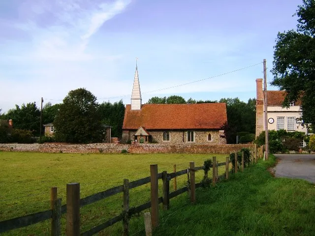 St Barnabas Chapel, Chappel, Essex. Houses cluster around the small 14th century church, originally a chapel. The village was allowed a chapel of its own in 1355, because bad weather prevented attendance at church - hence the name.