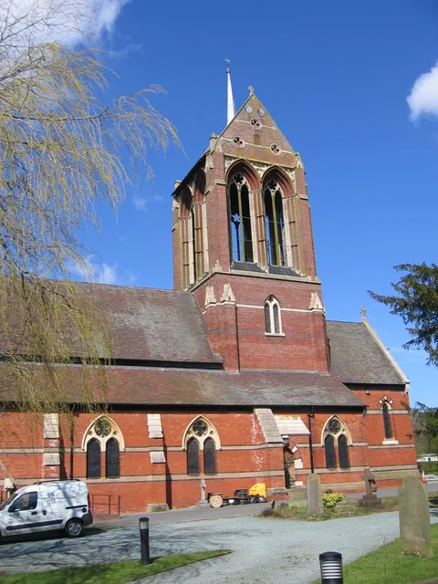 Crossing tower of the former parish church of St Mary, Wythall, Worcestershire, seen from the south. The church building is now redundant and the van and the cable drums are evidence that it is now used by a firm of electrical contractors. The current occupants have maintained the major internal features and repaired the structure of the building. St Mary's congregation now meets in Coppice Primary School in nearby Hollywood.