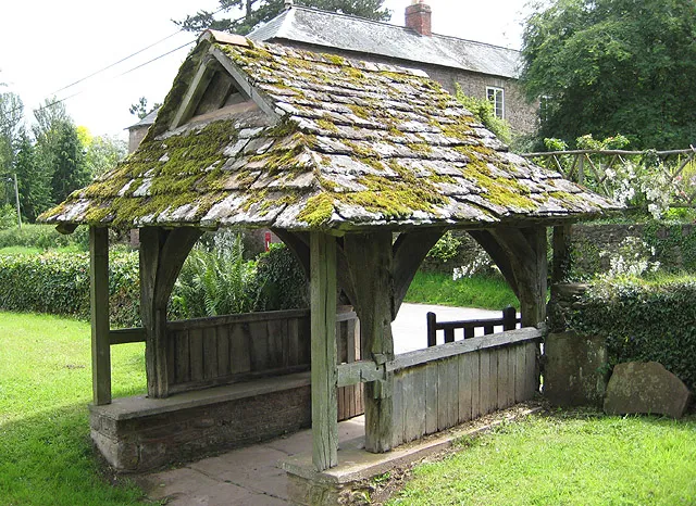 15th century lych gate, near to Llanwarne, Herefordshire, Great Britain. According to an information board located under the roof timbers of the lych gate, parts of this were constructed in the 15th century, at the same time as the tower. Abandoned in 1864 due to constant flooding from the Gamber Brook, the nearby roofless church is now in a fairly dangerous condition.