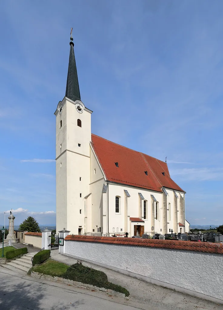 Südwestansicht der röm.-kath. Pfarrkirche hl. Johannes der Täufer in Sindelburg, ein Ortsteil der niederösterreichischen Marktgemeinde Wallsee-Sindelburg. Eine in erhöhter Lage erbaute zweischiffige spätgotische Hallenkirche mit einem vorgestellten mittelalterlichen Westturm, der 1705 erhöht und 1847 mit einem Spitzhelm versehen wurde.