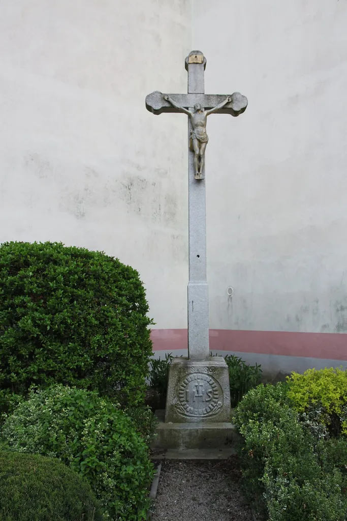 A stone wayside cross from 1886 at the Church of St. Vitus in Rudolfov, České Budějovice District, South Bohemian Region, Czechia.