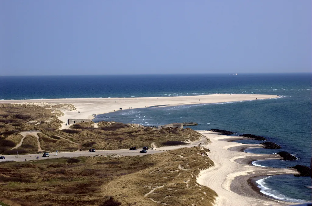This is the northmost point of Jylland, Denmark. The very northmost projection of land is called Grenen in Danish, and the general area is, just as the nearby town, called Skagen (the area is sometimes also referred to as The Skaw in English). Location: Shot from the top of the Skagen lighthouse located just north of Skagen city. Camera: Nikon D50 using a 70-300mm lens (at 70mm when the photo was taken).