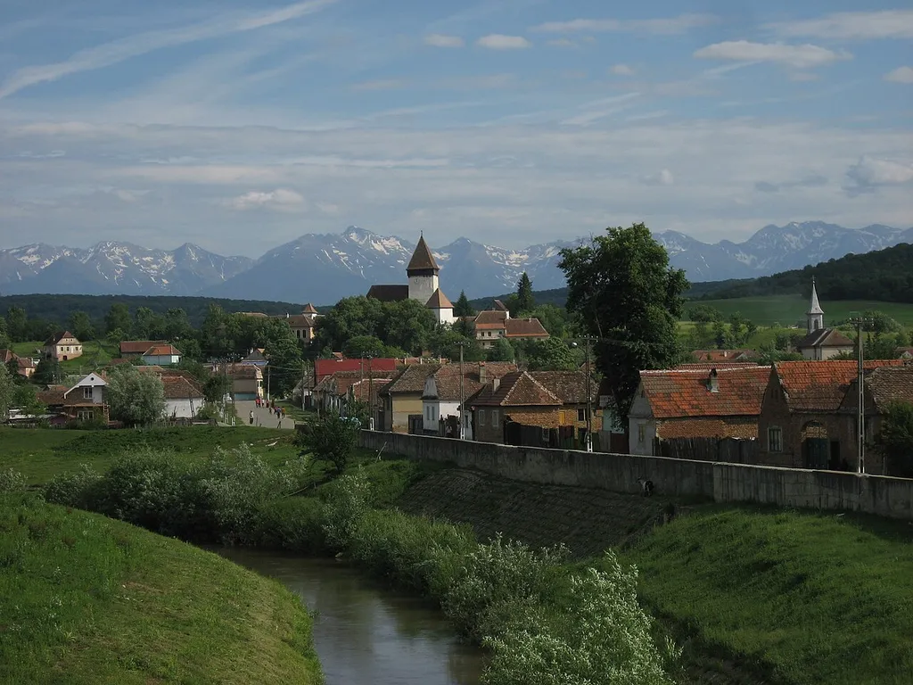 Hosman with the Făgăraș-mountains in the back, shot from the bridge at the village entrance