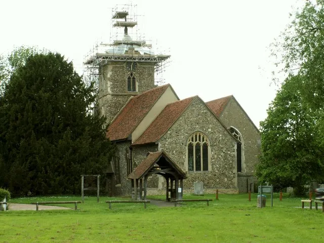 St. Peter's church, Roydon, Essex. This church dates from the 13th and 14th century and is seen here looking east across the small village green. The picture shows the tower being restored.