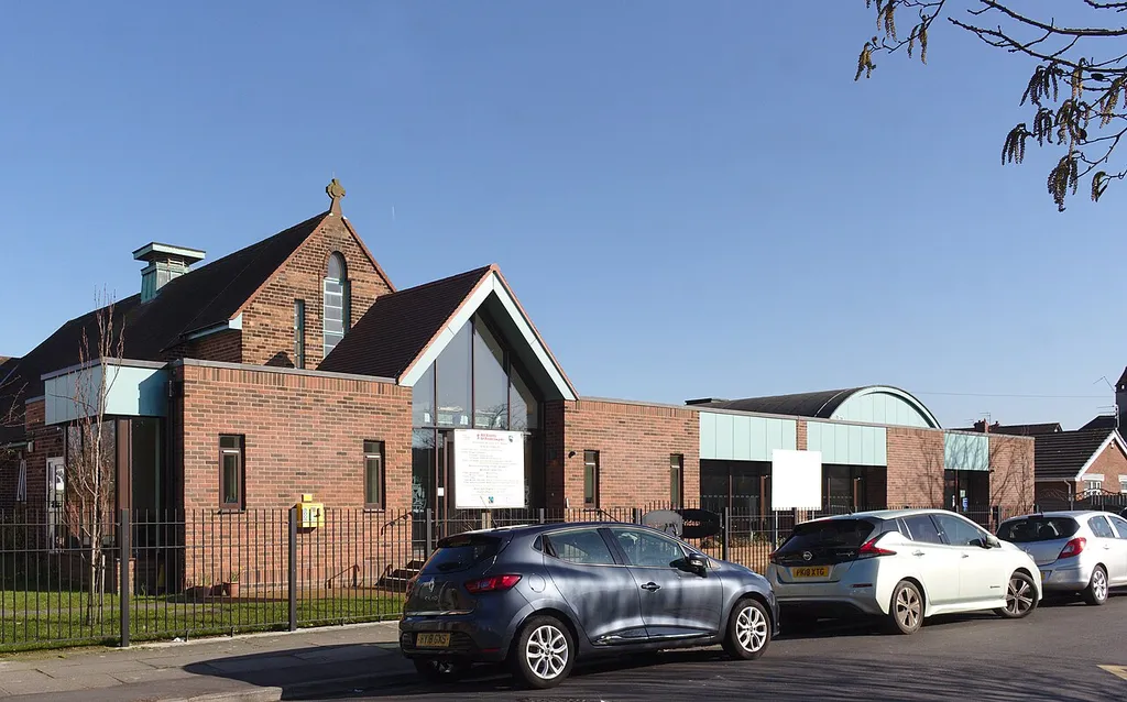 View south along Forefield Lane, with the church ot the left and its hall at the right.