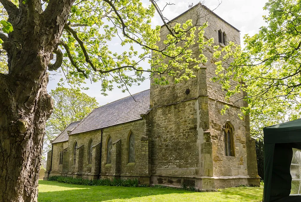 The church dates from the 13th century onwards. There is a western tower, nave, and chancel. The tower dates from the 15th century with later 19th-century work. The nave and chancel were rebuilt in 1841, although the chancel arch dates from the 13th century. All fittings including the font are 19th century. The interior is plain and whitewashed.