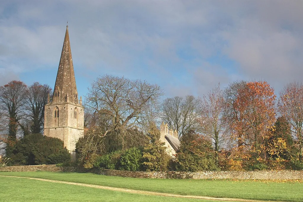 Broadwell, Oxfordshire: view loking northeast at steeple of St Peter's parish church &amp; thatched roof of cottages.