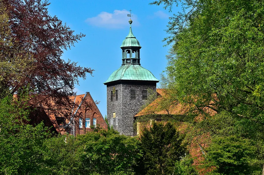 The church tower of the St. John's Church (view from the monastery lake) in Walsrode in the Lüneburg Heath, Germany
