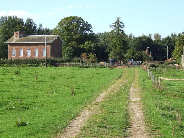 Footpath and farm road, Langton-by-Partney, Lincolnshire. The brick building on the left is SS Peter and Paul parish church, built in 1725.